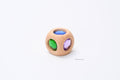 One Bauspiel Magic Cube with rounded wooden edges and blue, green and purple coloured inserts.