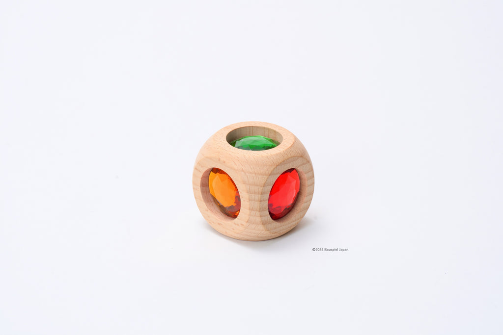 Another view of one Bauspiel Magic Cube, showing green, orange and red coloured inserts.