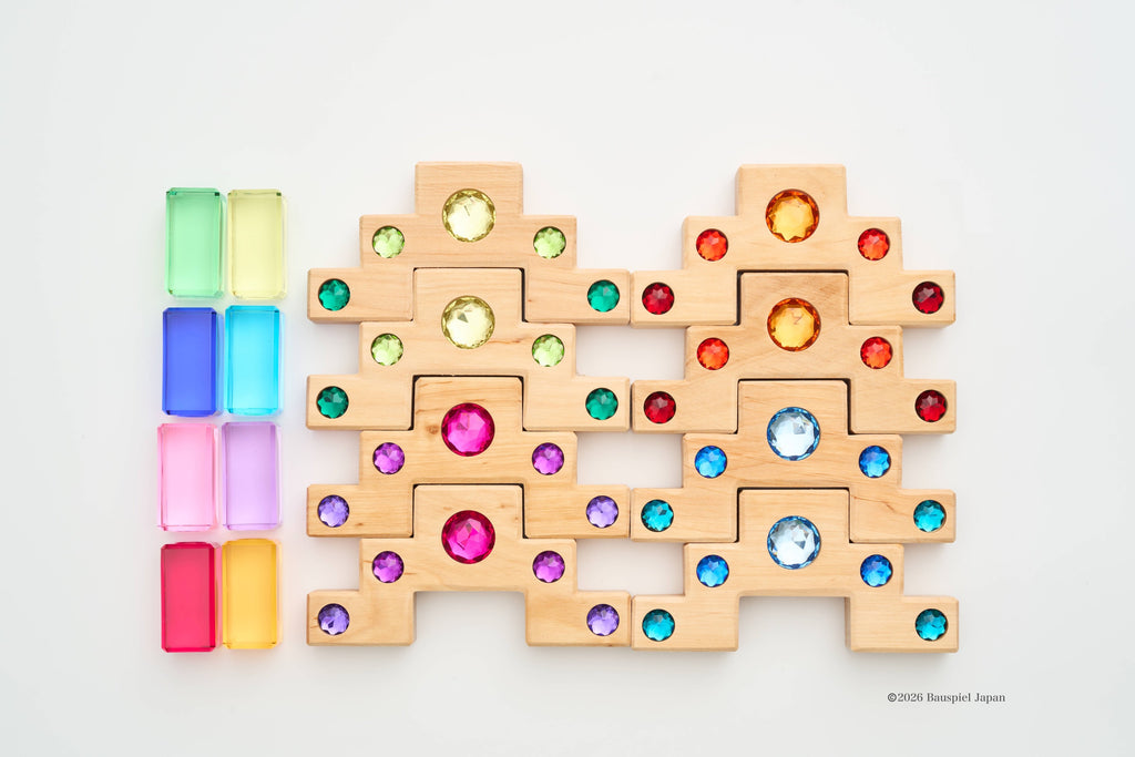 The eight wooden staircase blocks and eight translucent blocks in Bauspiel's smaller Light set, laid out together.