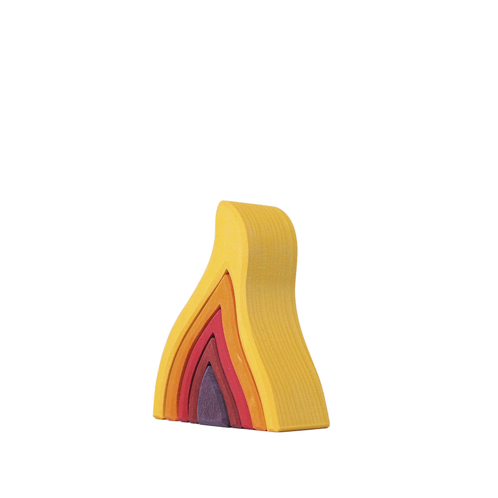 GRIMM’S Mini Fire Stacker with five nested wooden flame-shaped pieces in warm colours.
