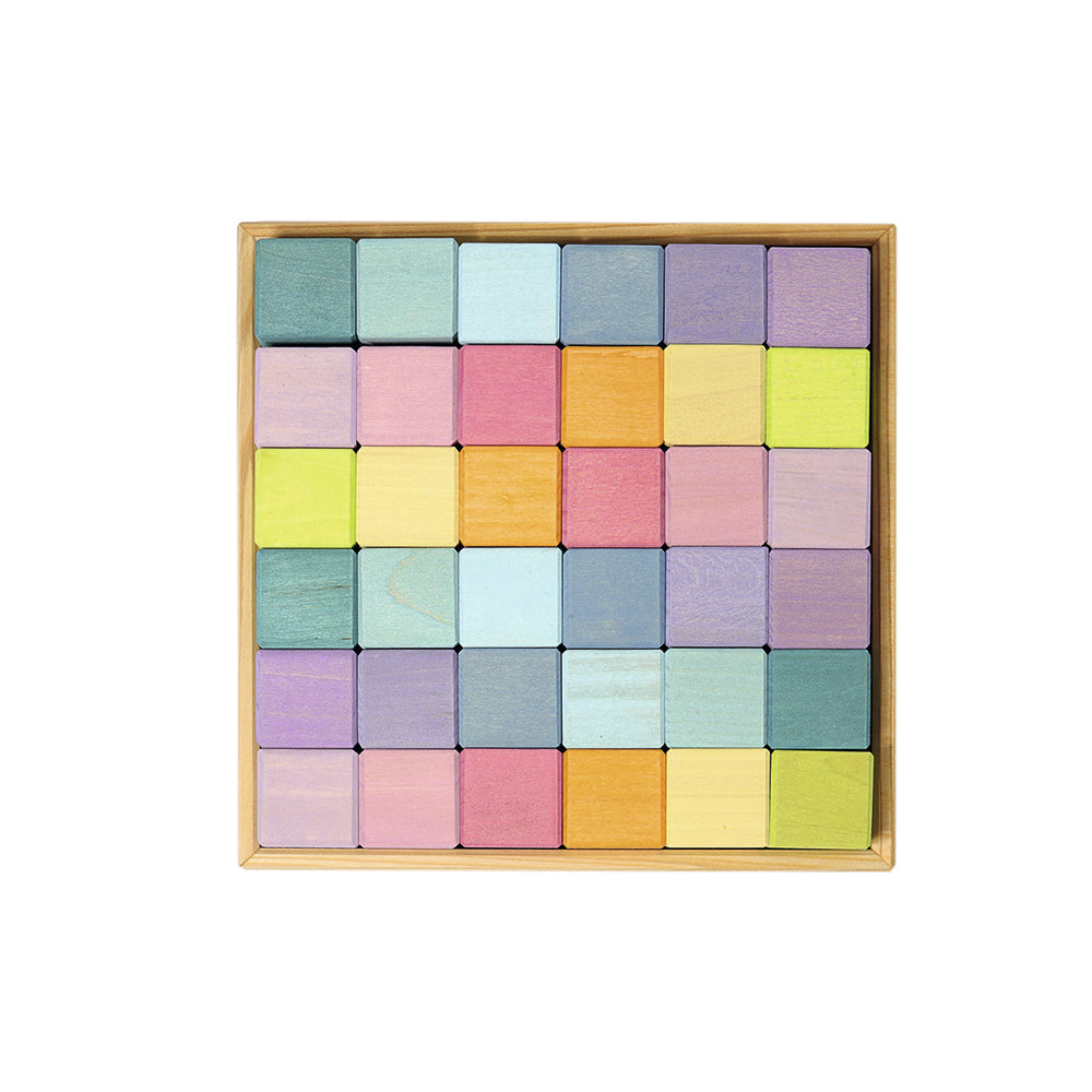 GRIMM’S Pastel Mosaic Blocks: 36 coloured wooden cubes arranged in their square wooden frame.